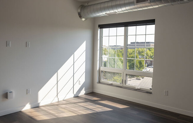 an empty room with a large window at The Landing at 1001 NP, Fargo, ND 58102