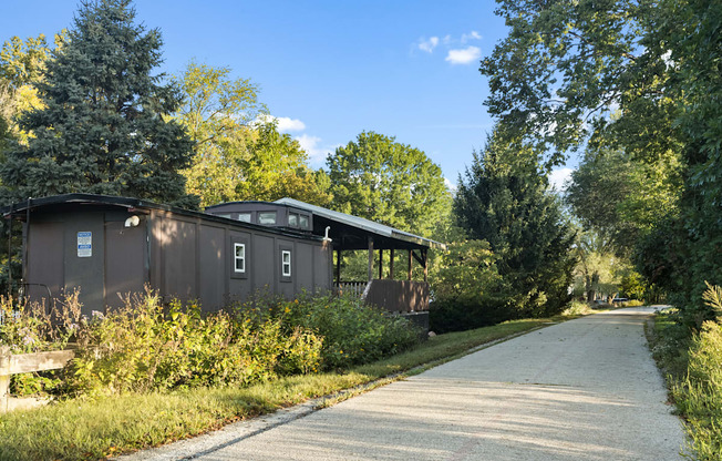 a house on the side of a road next to a path