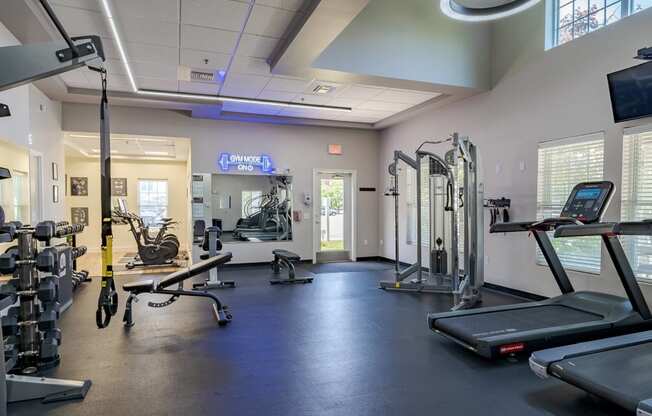 a gym with weights and other exercise equipment at the monarch apartments
