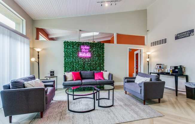 a living room with couches and chairs and a green wall