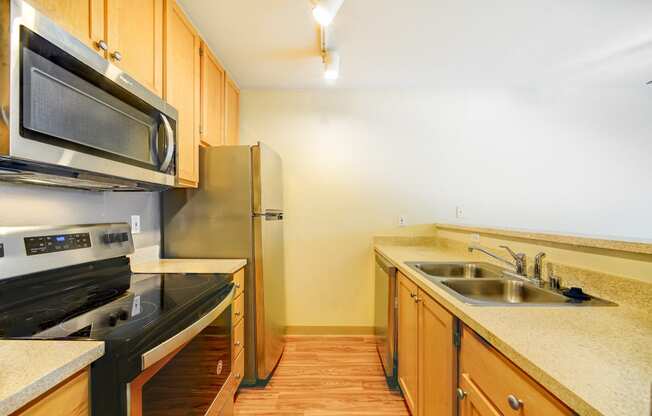 a kitchen with a sink and a stove and a refrigerator