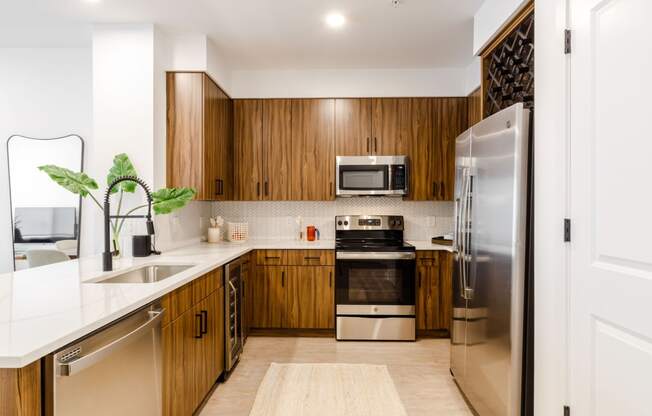 a kitchen with wooden cabinets and stainless steel appliances at Dey & Bergen, New Jersey, 07029