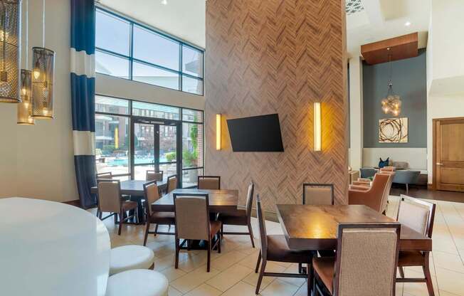 A modern dining room with a wooden patterned wall and a large table with chairs.