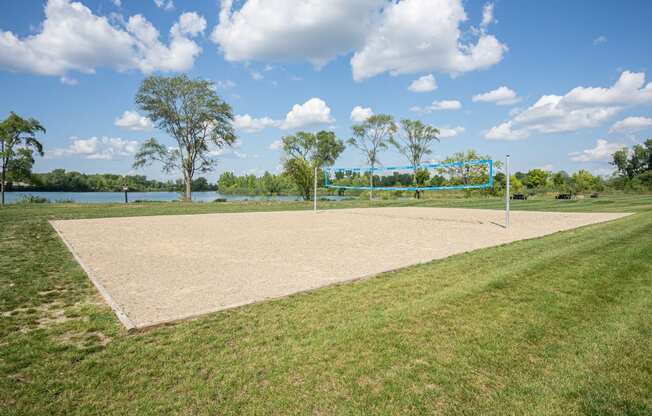 Outdoor sand volleyball court. Large grassy area sur