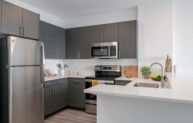 a kitchen with stainless steel appliances and a white counter top