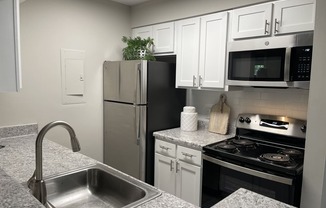 a kitchen with granite countertops and stainless steel appliances