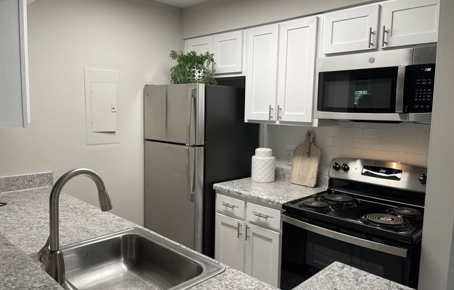 a kitchen with granite countertops and stainless steel appliances