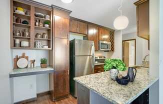 a kitchen with stainless steel appliances and granite counter tops