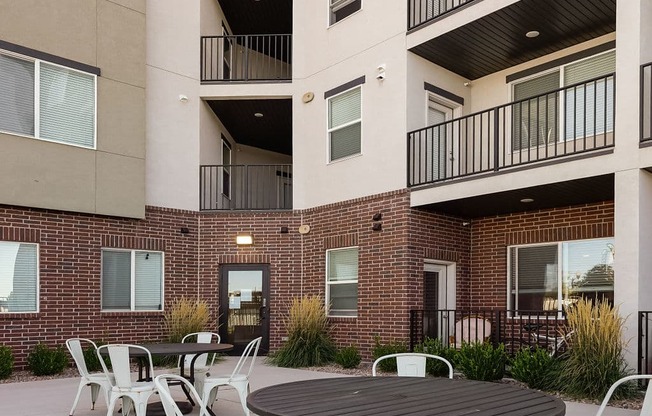 our apartments have a large patio with chairs and tables