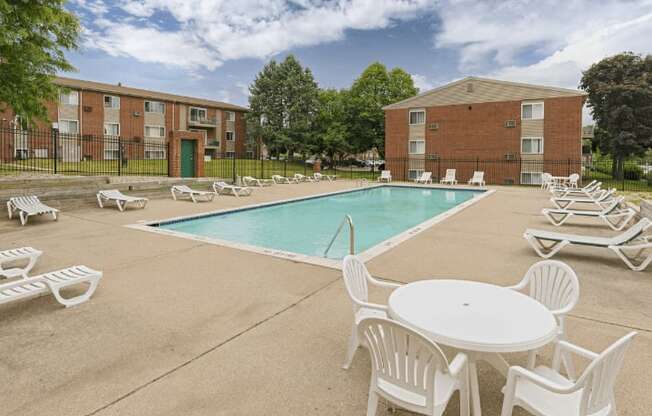 our apartments offer a swimming pool with tables and chairs