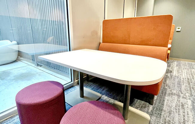 clubroom/resident lounge small work/study area with bench, table and modular seating at The Residences at Delmar DivINe, St Louis, Missouri