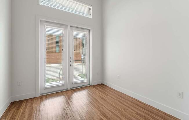 A room with a sliding door and a window.