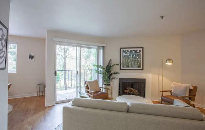 Living room with a couch and chairs and a fireplace