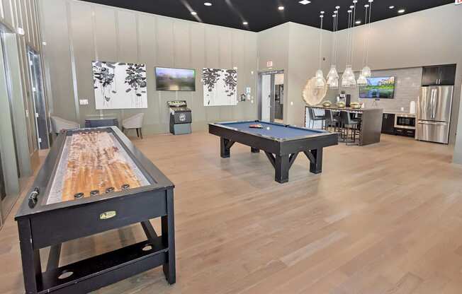 a game room with three billiards tables