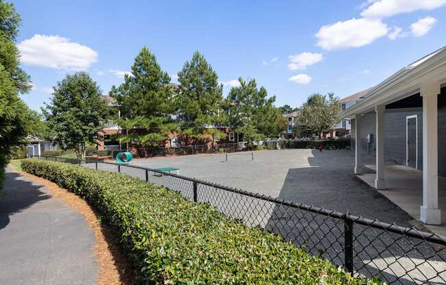 A black fence runs along a sidewalk.