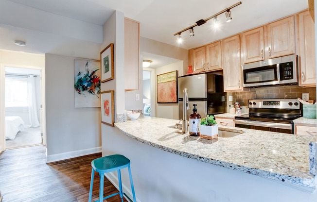 a kitchen with a granite counter top and stainless steel appliances