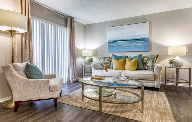 a living room with a couch and chairs and a coffee table