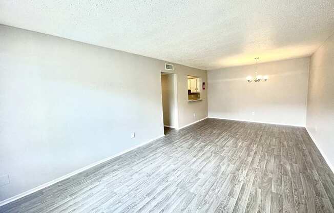 an empty living room with wood floors and white walls at Cambridge Village Apartments, Houston, TX ? 