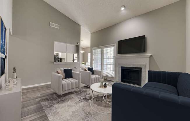 A living room with a fireplace and a television.