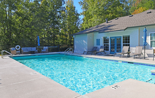 a swimming pool with a house in the background