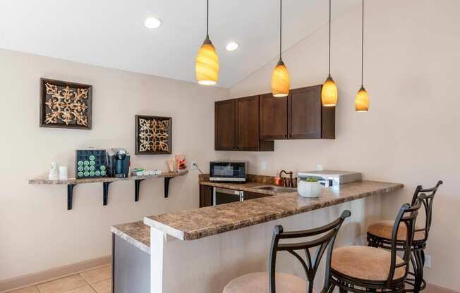 a kitchen with bar stools and a counter top with