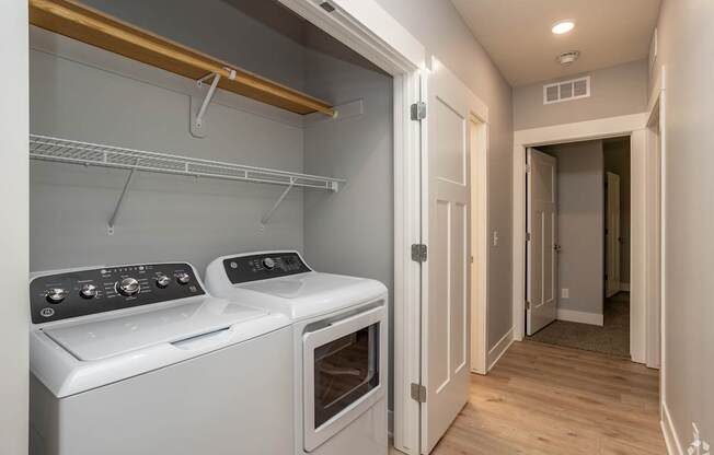 A white oven and stove top are in a small kitchen.