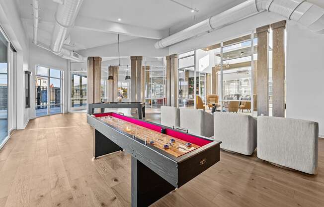 a games room with a ping pong table and couches