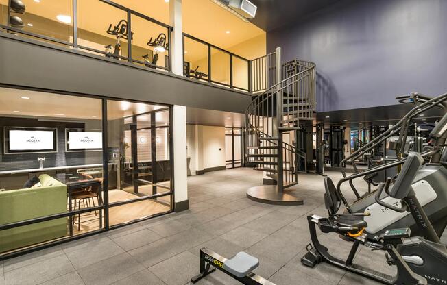 Stay active with ease in the two-level fitness studio at Modera Beaverton, featuring cutting-edge equipment and contemporary design.