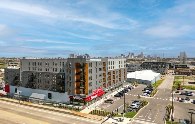 an aerial view of an apartment building and a parking lot