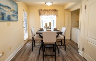 the view of a dining room with a table and chairs
