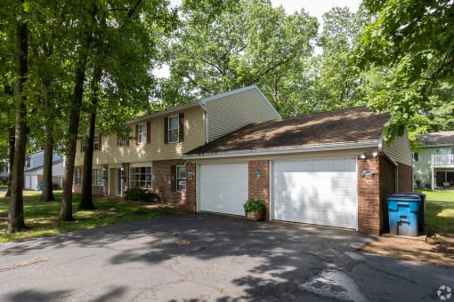 the front of a house with a white garage door