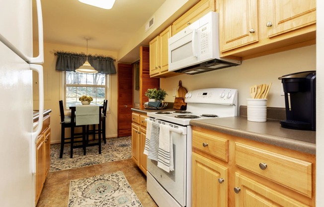Large eat in kitchen with washer and dryer in unit at Spring Hill Apartments & Townhomes, Baltimore, MD 21234
