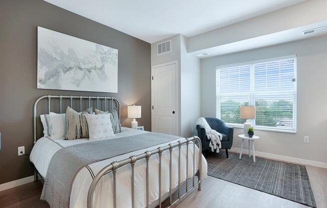 Bedroom with gray accept wall, bed and window