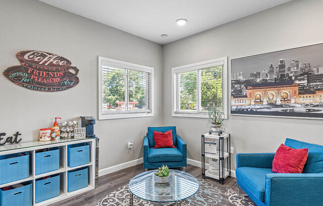 a living room with two blue couches and a table