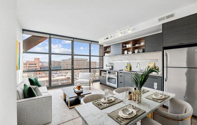 a living room with a kitchen and a large window