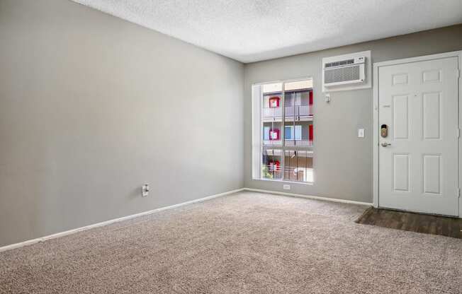 an empty room with carpet and a white door