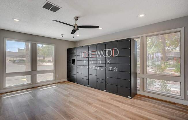 A room with a wooden floor and a sign that says "House Park Apartments".