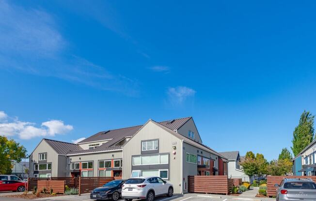 the exterior of a house with cars parked in front of it