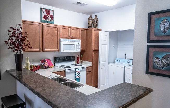 Fully-equippd Kitchen with Bar and in apartment Laundry Area
