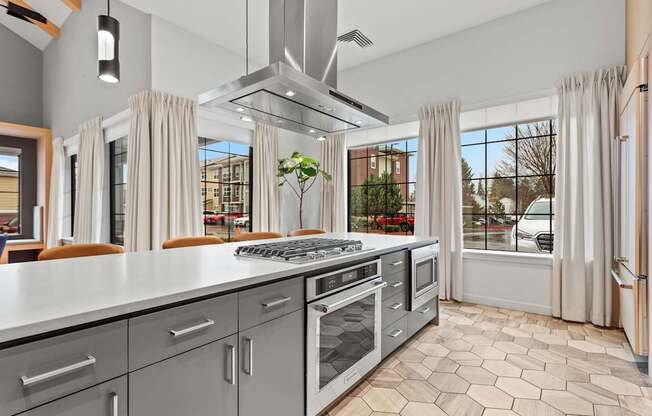 A modern kitchen with a large island and stainless steel appliances.