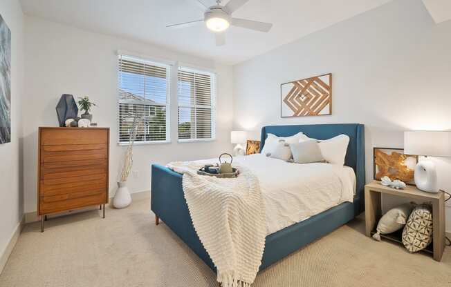 a bedroom with a bed and a ceiling fan