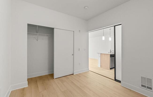 A room with a white door and a white wall.