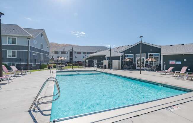 a swimming pool with apartments in the background