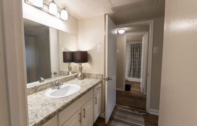 This is a photo of the primary bathroom in the 965 square foot 2 bedroom, 2 bath  apartment at Harvard Square Apartments, in Dallas, TX.