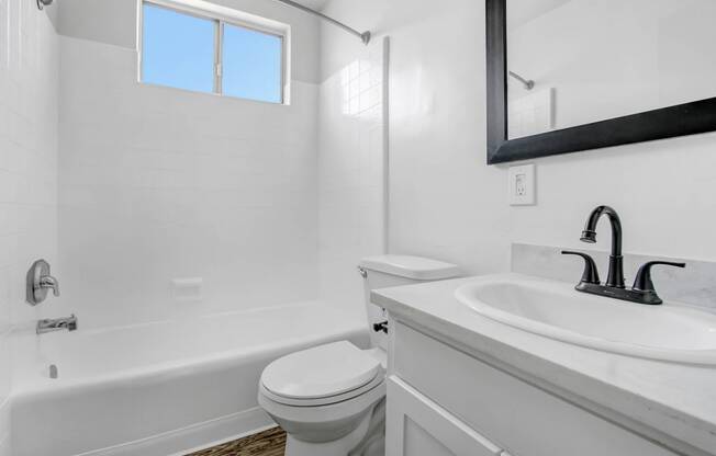 a bathroom with a sink toilet and a bath tub