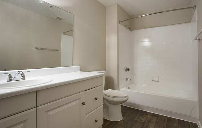 Full bath with white cabinets and countertops