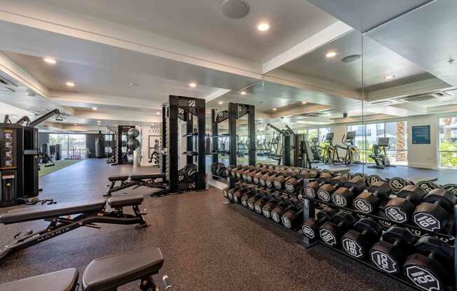 a spacious fitness center with weights and other exercise equipment