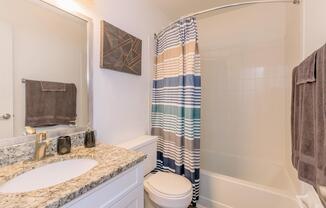 a shower curtain next to a sink