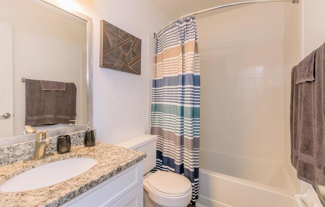 a shower curtain next to a sink