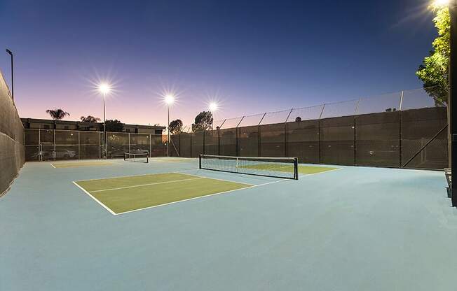 Community Tennis Court with Nets at Madison Park Apartments located in Anaheim, CA.